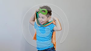 Little boy playing a superhero. Kid in an Superhero`s costume. happy child. green mask, nature care concept