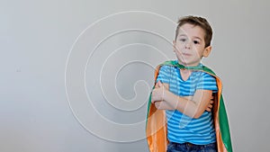 Little boy playing a superhero. Kid in an Superhero`s costume. happy child. green mask, nature care concept