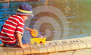 Little boy playing in swimming pool at beach