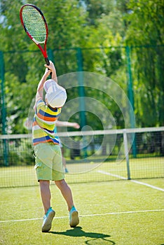 Little boy playing tennis