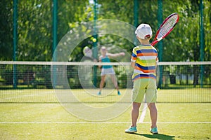 Little boy playing tennis