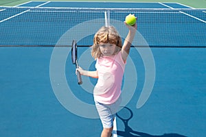 Little boy playing tennis. Sport kids. Child with tennis racket on tennis court. Training for young kid, healthy