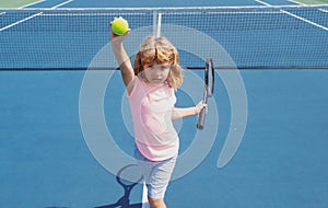 Little boy playing tennis. Sport kids. Child with tennis racket on tennis court. Training for young kid, healthy