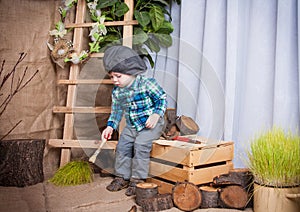 Little boy is playing with the tools of a carpenter.