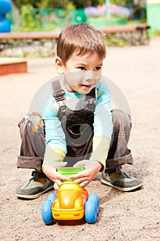 Little boy playing in the toy car