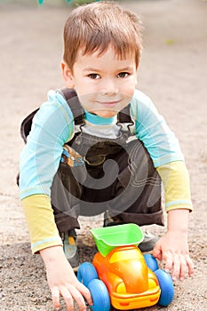 Little boy playing in the toy car