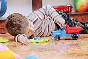 Little Boy Playing with Toy Car