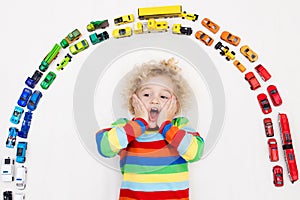 Little boy playing with toy cars. Toys for kids.