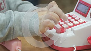 Little boy playing with toy phone indoors