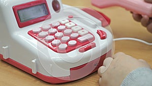 Little boy playing with toy phone indoors