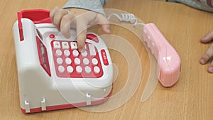 Little boy playing with toy phone indoors