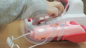 Little boy playing with toy phone indoors