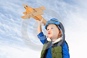 Little boy playing with toy plane