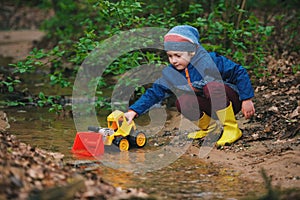 Little boy playing with toy truck