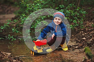 Little boy playing with toy truck