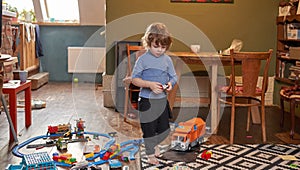 little boy is playing with toys in the room