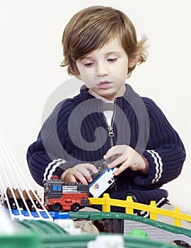 Little boy playing with train set