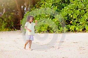 Little boy playing on tropical beach