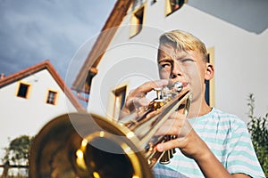 Little boy playing the trumpet