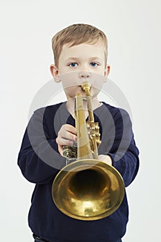 Little boy playing trumpet.music child.musical instrument