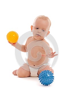 Little boy playing with two massage balls