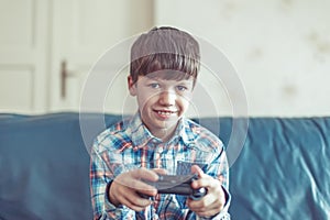Little boy playing video game by controller
