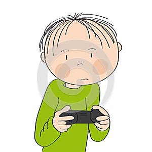 Little boy playing video games on game console, holding joystick, being very concentrated.