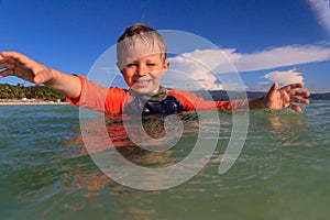 Little boy playing with water on the beach