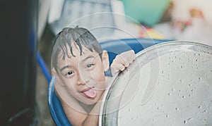 Little boy playing water splash at the backyard outdoor activities summer time