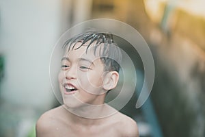 Little boy playing water splash at the backyard outdoor activities summer time