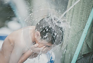 Little boy playing water splash at the backyard outdoor activities summer time