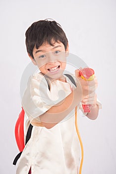 Little boy playing water on water festival Thailand new year with hand