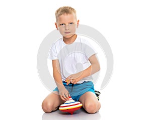 Little boy playing with a whirligig.