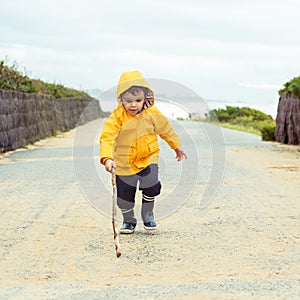 Little boy playing with wood stick