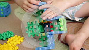 Little boy plays with constructor on the floor