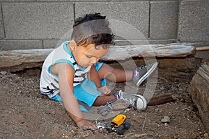 Little Boy Plays In Dirt