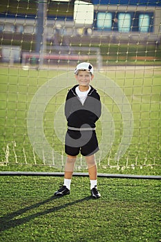 Little boy plays football