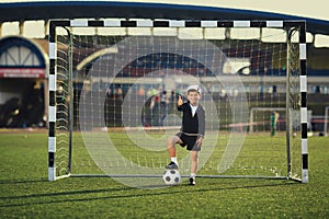 Little boy plays football