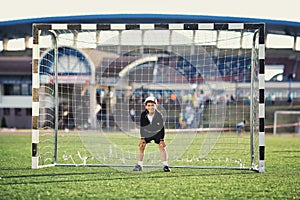 Little boy plays football