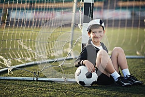 Little boy plays football