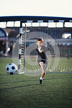 Little boy plays football