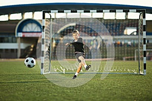 Little boy plays football