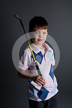 Little boy plays mini golf