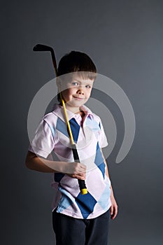 Little boy plays mini golf