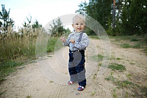 Little boy plays on the road