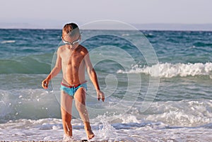 Little boy plays in sea