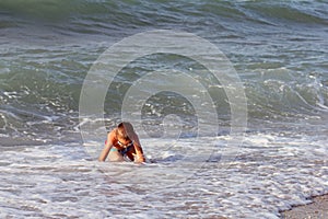 Little boy plays in sea