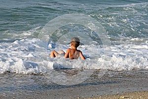 Little boy plays in sea