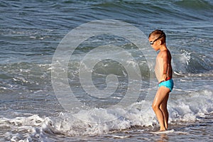 Little boy plays in sea