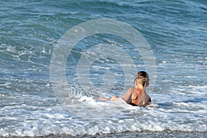 Little boy plays in sea